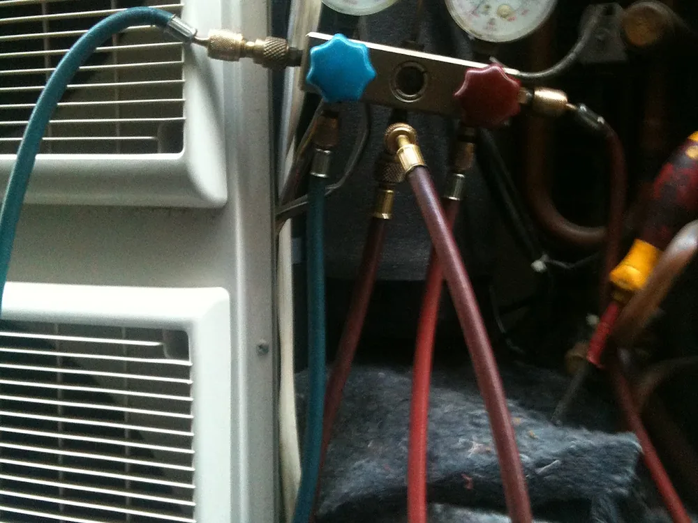 Refrigerant gauges and hoses connected to a split system during a service