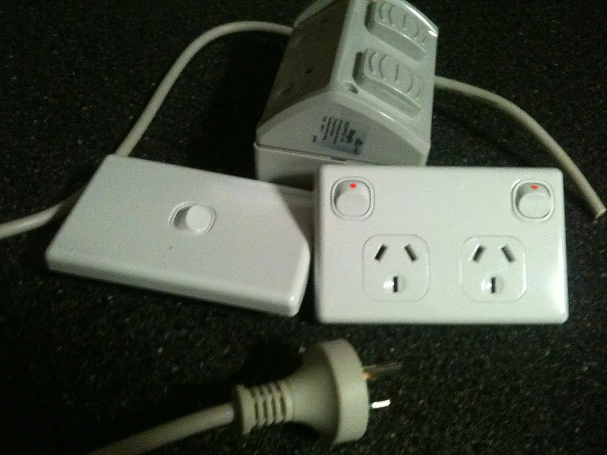 A light switch, a double power point and a plug laid out before installation